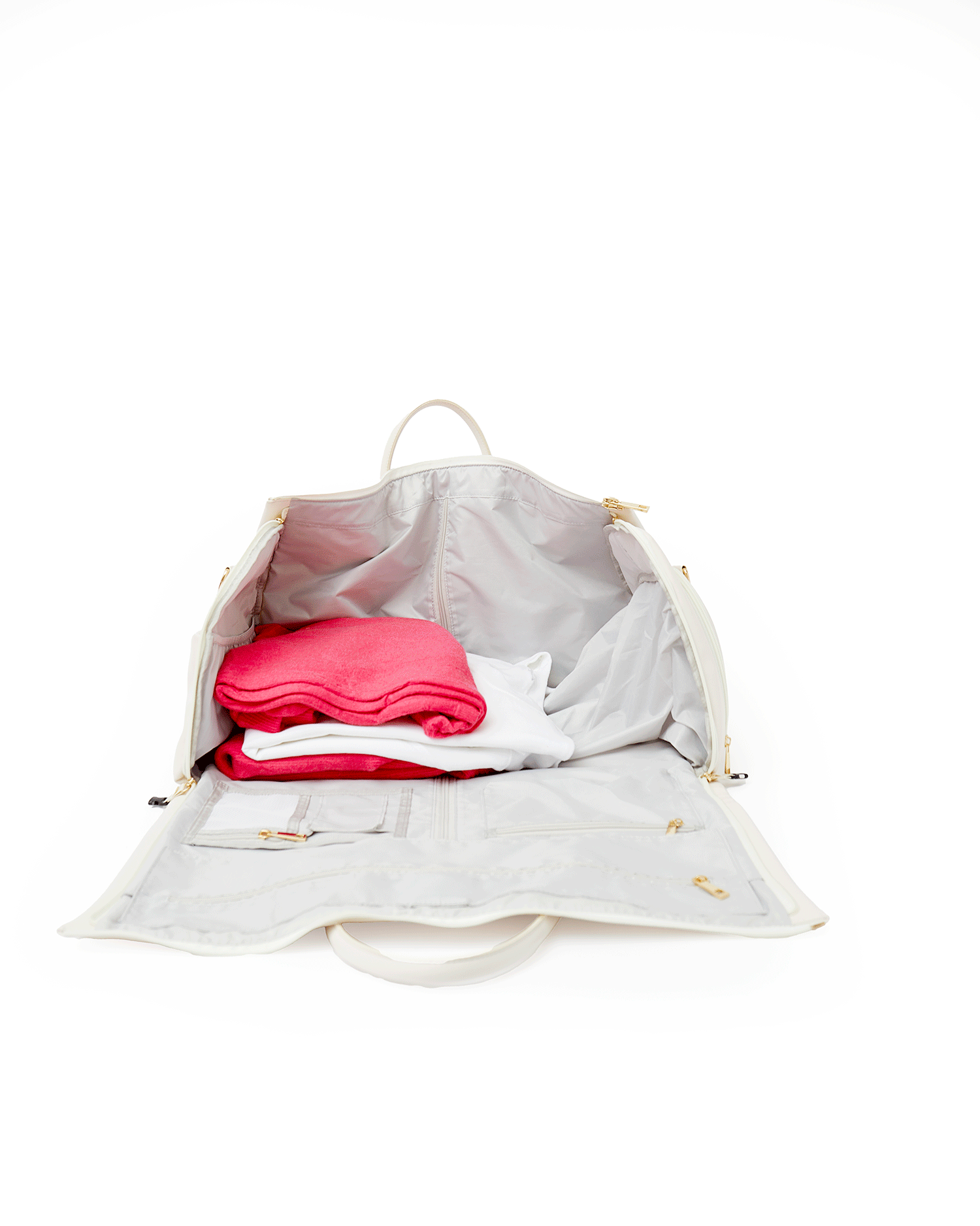 A white, tan, and black duffel are personalized with embroidery.