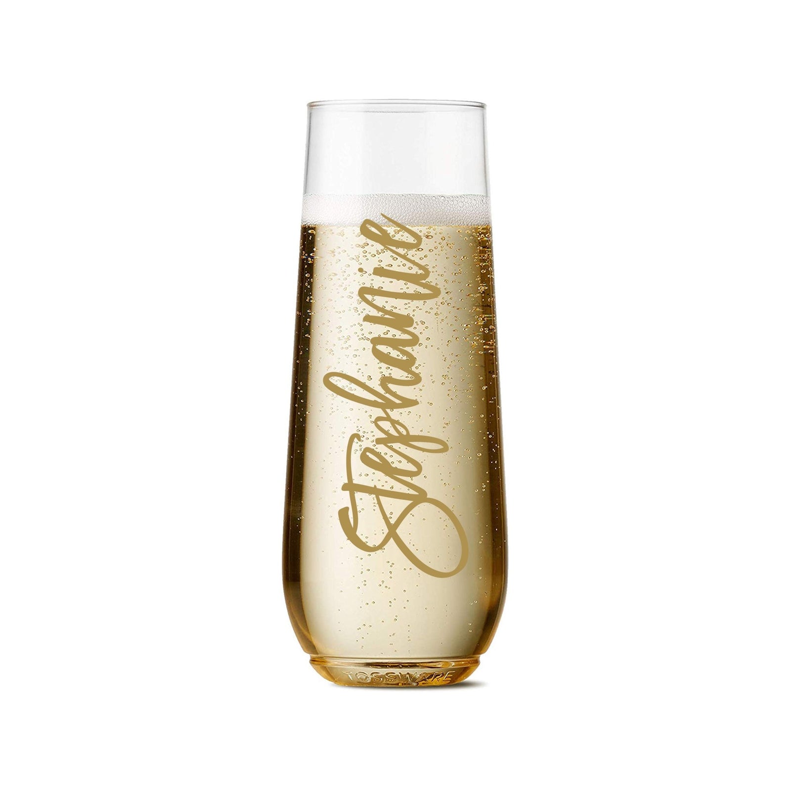 A champagne flute is customized with a name in a script gold font.