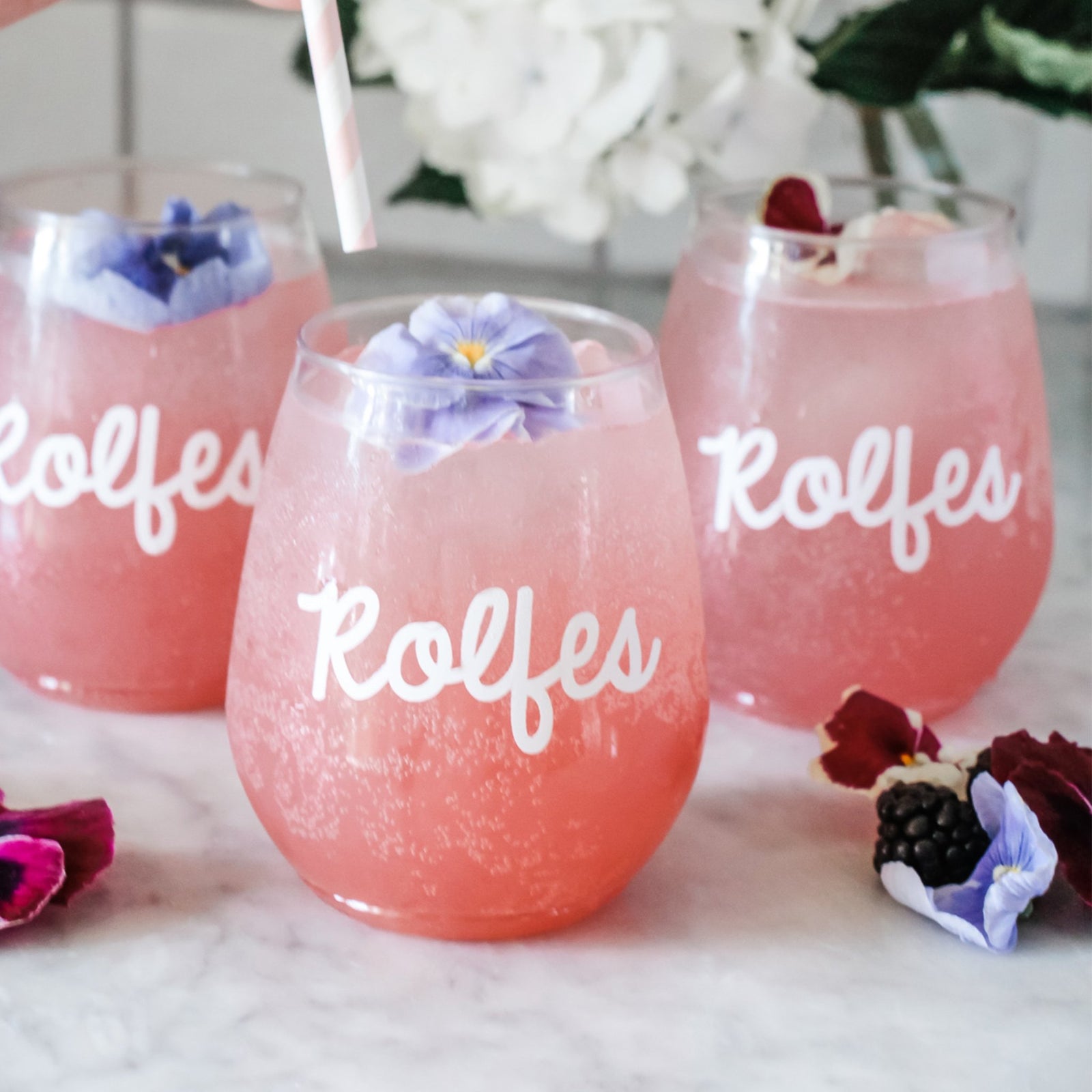 An acrylic wine glass reads "Hannah" on the front in cursive