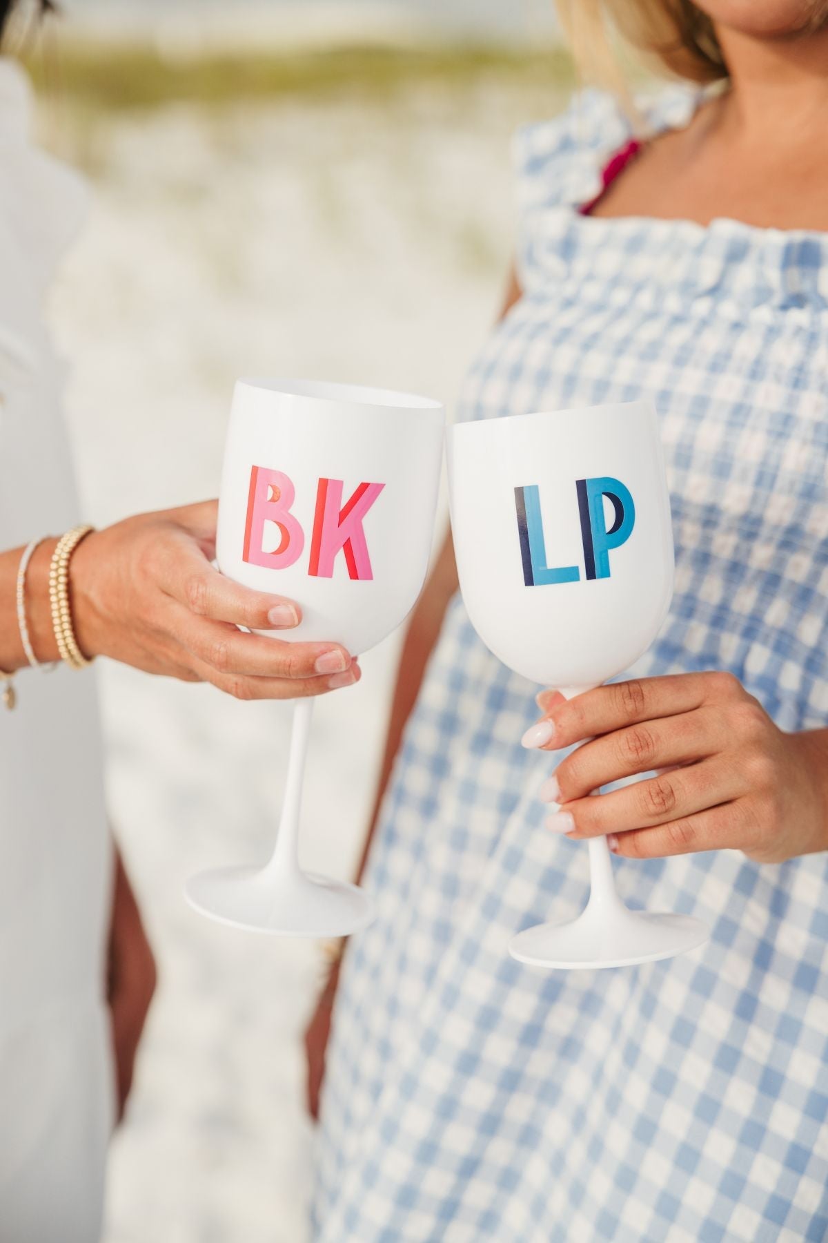 A group of acrylic wine glasses are customized with monograms and custom wording