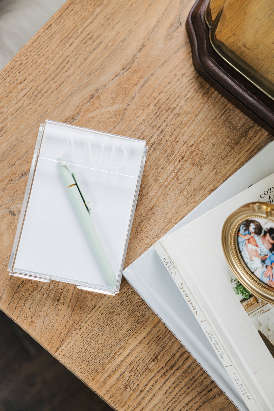A stylish and functional personalized acrylic notepad holder monogrammed with 'AMD,' designed for a sleek and organized workspace. The clear, modern design effortlessly blends with any office or home décor, making it a perfect gift or desk accessory. Pair it with other custom office essentials for a cohesive set.