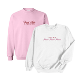 Set of two stylish crewneck sweatshirts featuring playful text designs. The pink sweatshirt reads 'Pinot Noir is for Lovers' in elegant white script, while the white sweatshirt displays 'Alexa Play Please Please Please' in bold pink and delicate red cursive. Perfect for cozy and trendy fashion enthusiasts.